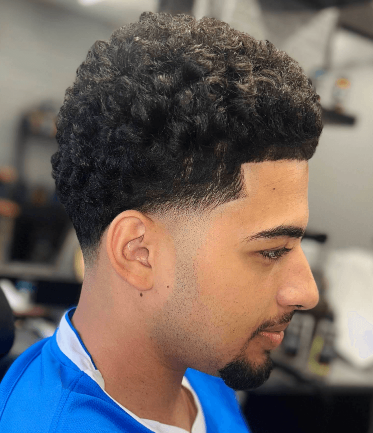 Crisp lineup and skin fade on thick curly hair
